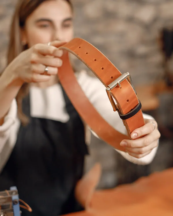Women Holding Premium Quality Brown Leather Belt